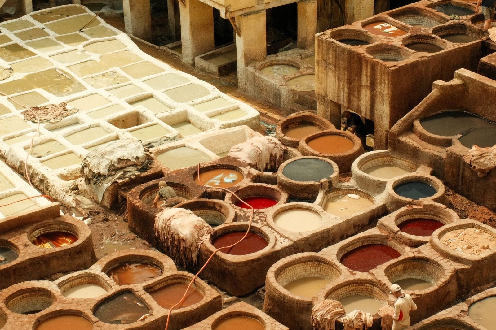 Dyed hides drying above the stone pits of a Fes tannery