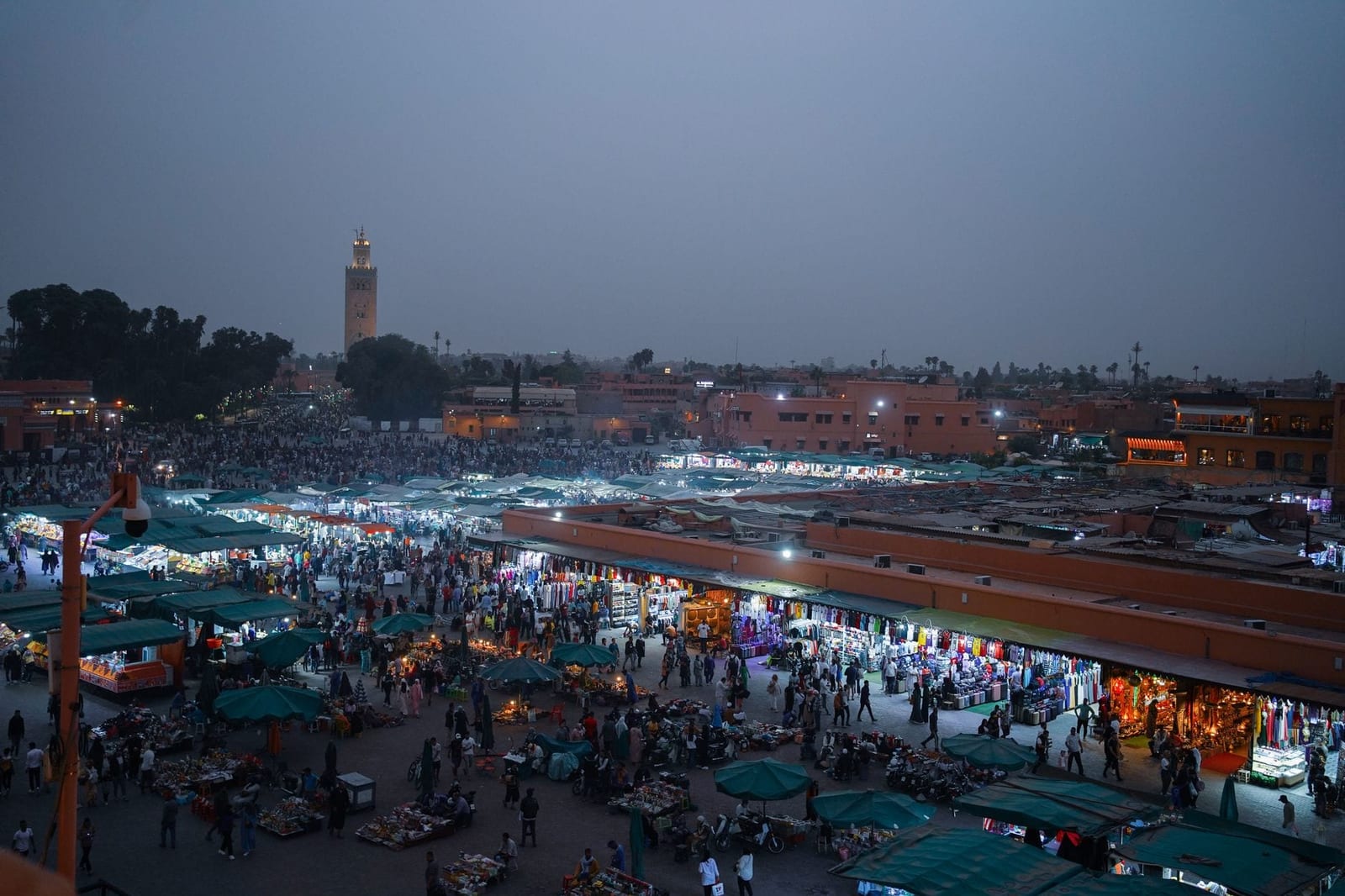 Crowds and market lights on Jemaa el-Fnaa square after sunset