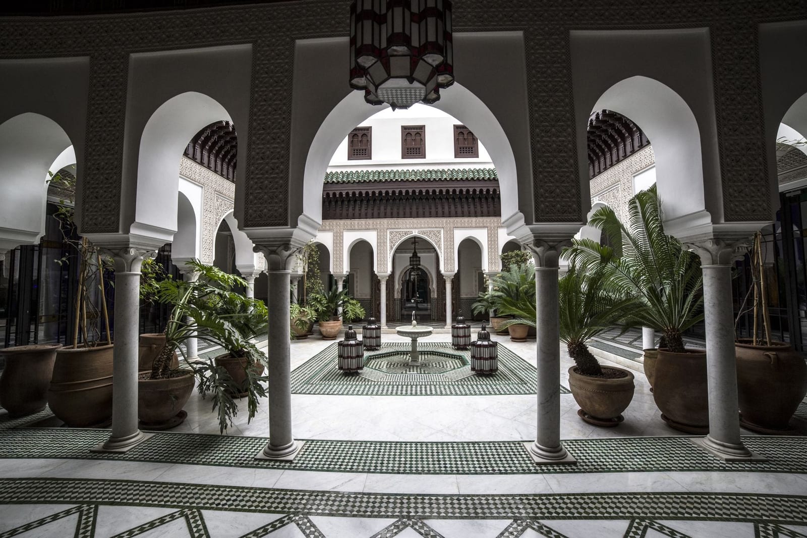 Glazed tilework and a fountain in the courtyard of a Marrakech riad