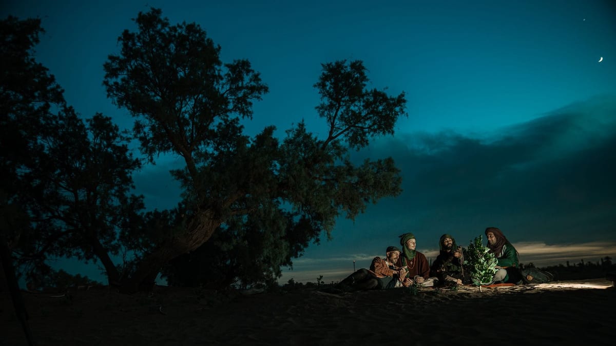 Tea and conversation around a campfire in the desert