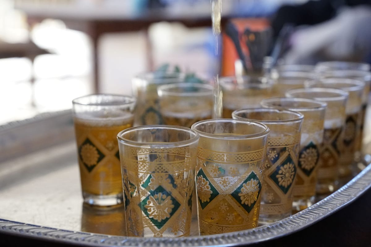 Moroccan mint tea poured from height into a glass